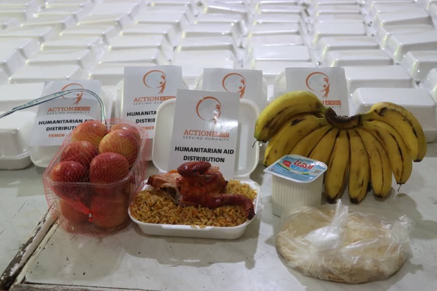 An Action4You hot meal box — rice, chicken, fruit and bread