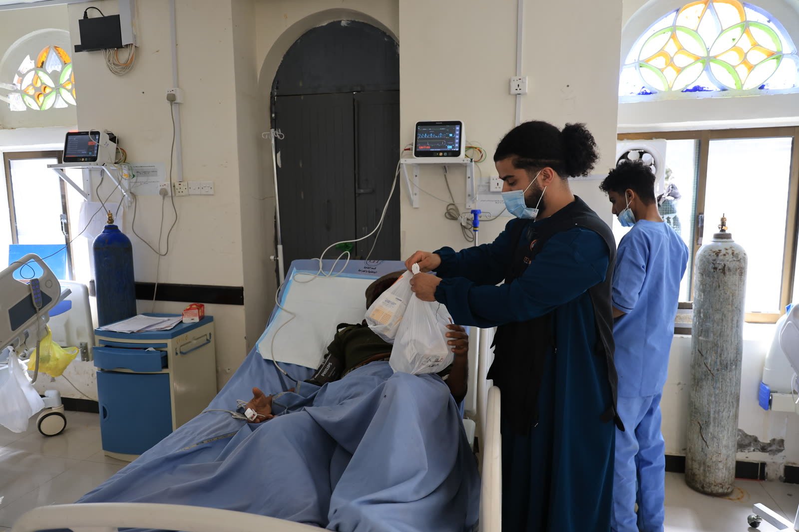 Action4You volunteer delivering medicine to a patient