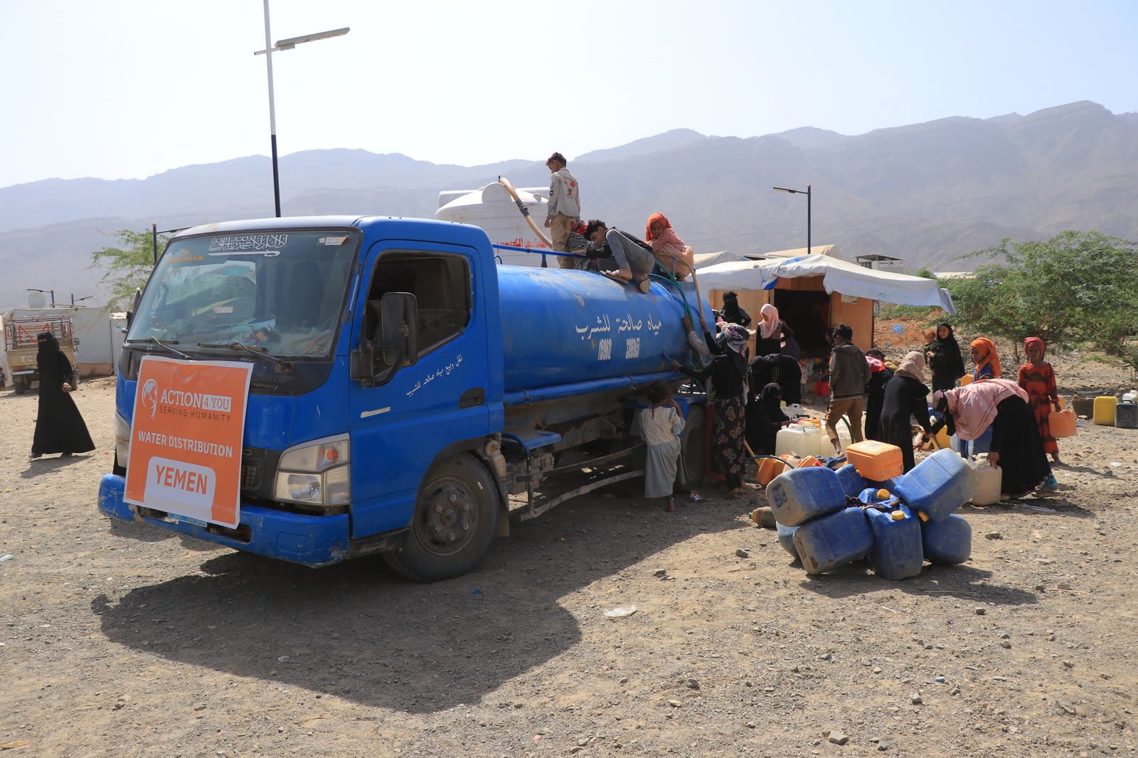 Action4You water distribution truck serving families
